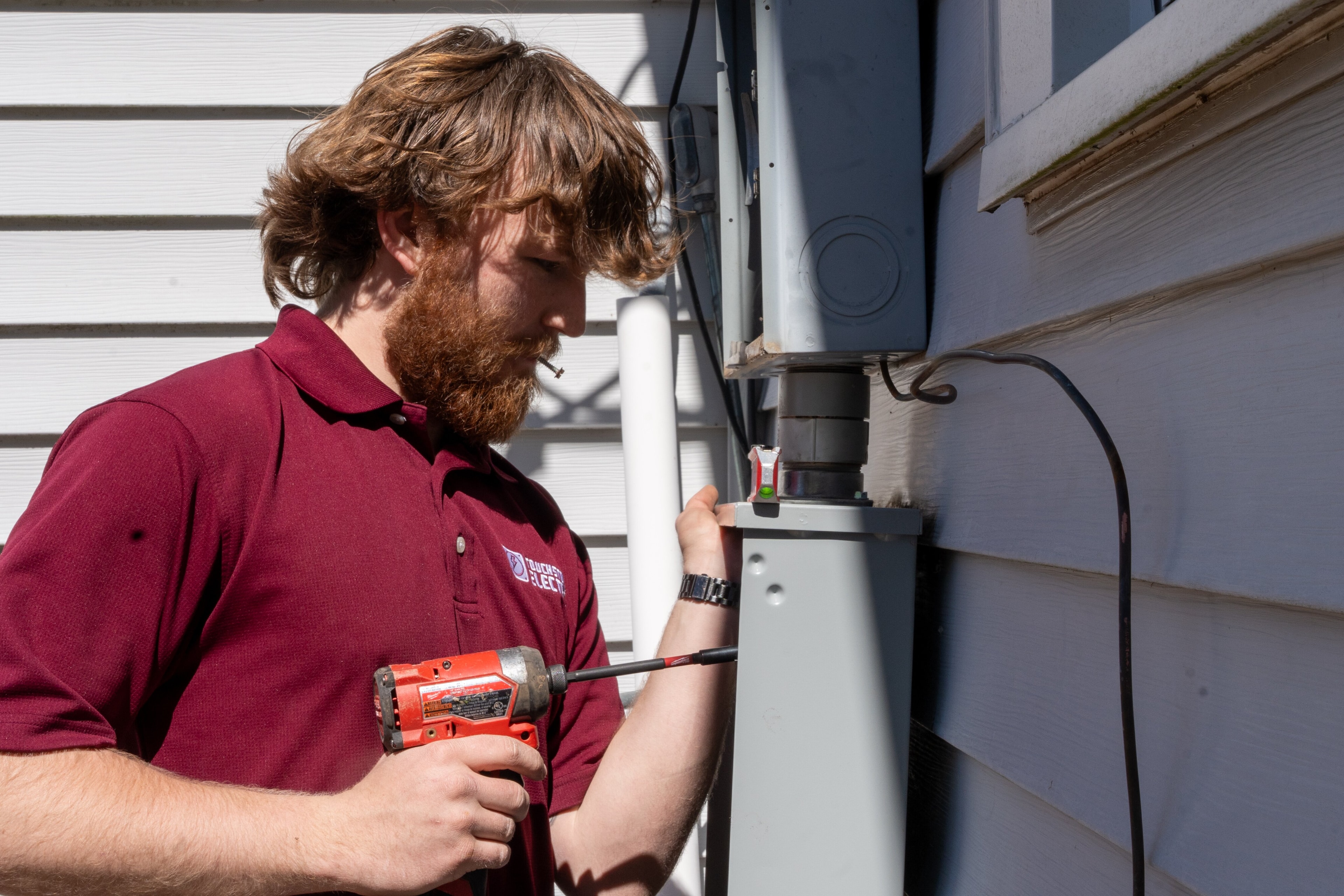 Touchstone Electric technician working on an electrical panel