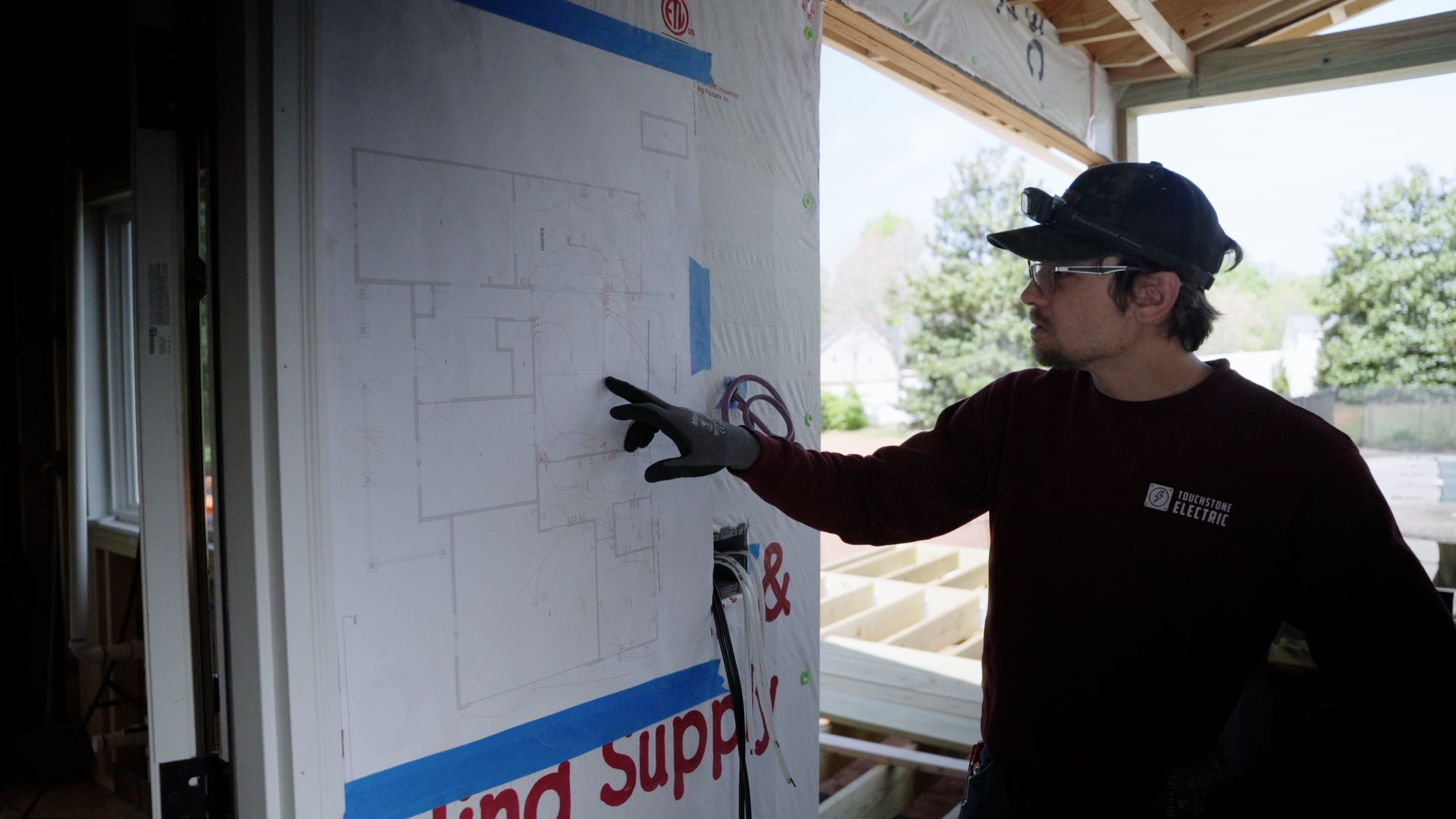 Electrician assessing electrical needs for subpanel installation