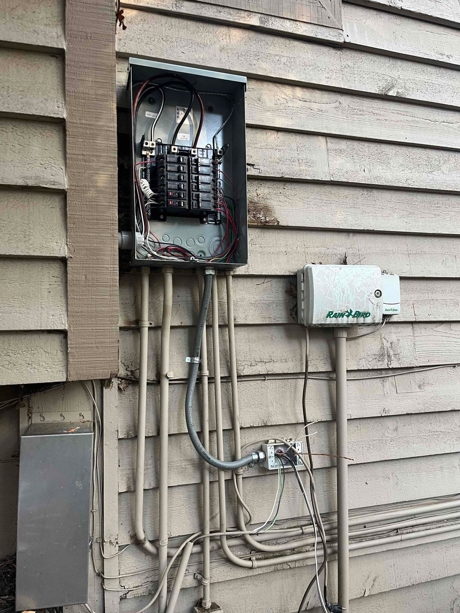 Electrician testing completed subpanel installation work